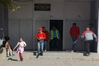 Minors with party symbols accompany parents at voting
